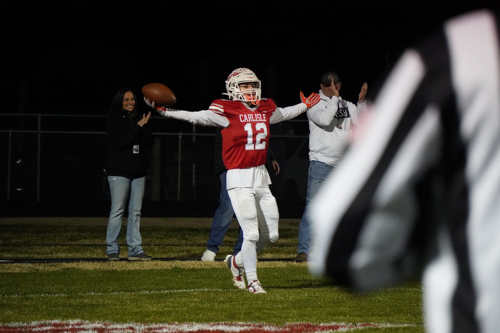 Carlisle’s Ashton Pelfrey (12) celebrates after scoring a touchdown against North Union in a Division V regional semifinal on Friday night at Laughlin Field. CHRIS VOGT / CONTRIBUTED