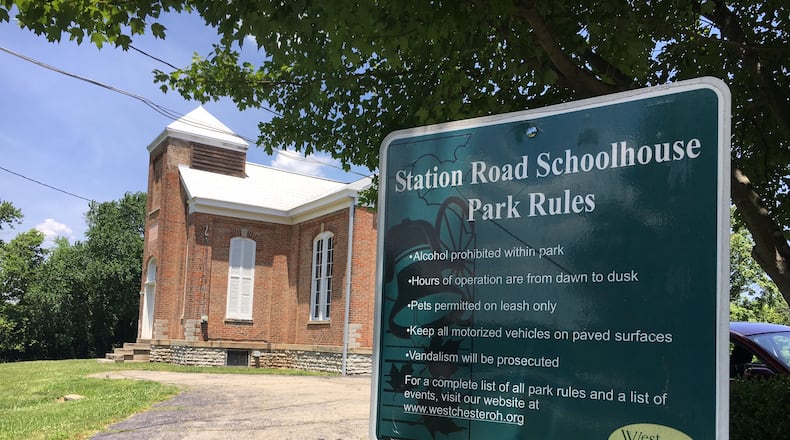 Neighbors of the Station Road schoolhouse have filed a motion to intervene in the lawsuit the owners of the Montessori School filed against West Chester Twp. The township has agreed to sell the property to the school, over objections of neighbors. MICHAEL D. CLARK/STAFF