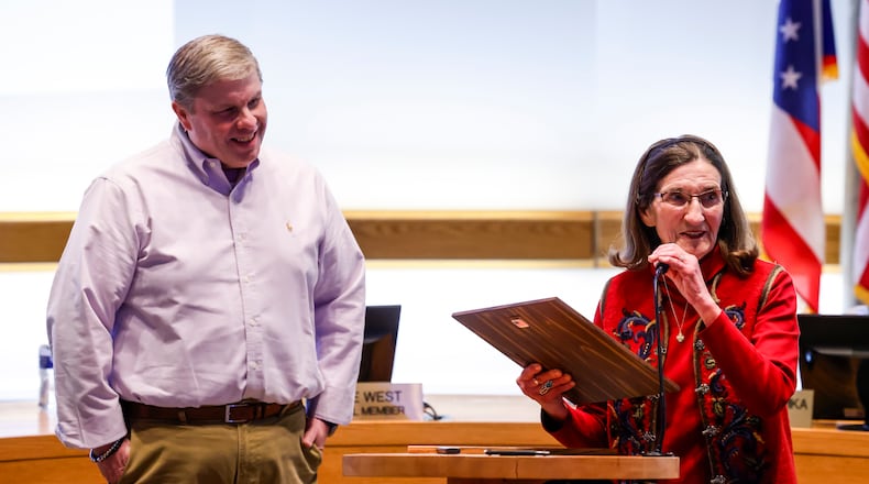 Matt Armbruster, son of the late Jim Armbruster, listens as Shirley Butts accepts the Armbruster Memorial Award during Tuesday's City Council meeting. NICK GRAHAM/STAFF