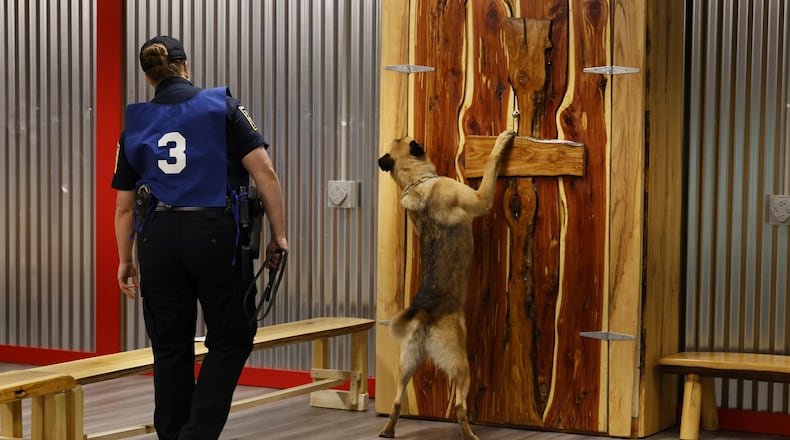 Middletown Police officer Lindsey Schwarber and Belgian Malinoir partner, Maverick, search for narcotics during the United States Police Canine Association region 5 trials Monday, May 16, 2022 at Berachah Church in Middletown. NICK GRAHAM/STAFF