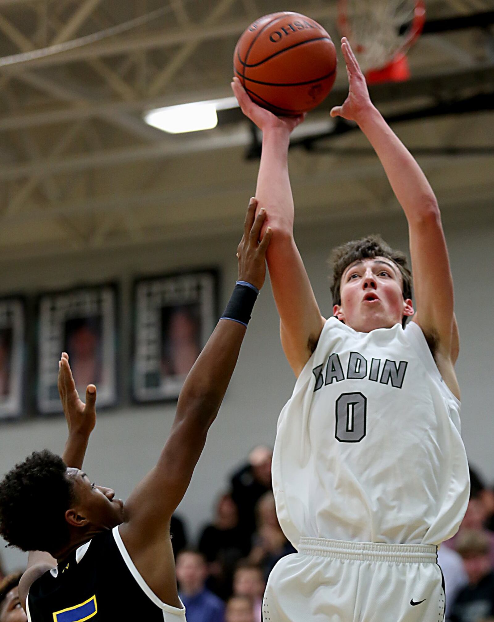 Badin center Jakob Tipton puts up a shot against Northwest forward Kaleb Williams during Wednesday night’s game at Mulcahey Gym in Hamilton. CONTRIBUTED PHOTO BY E.L. HUBBARD