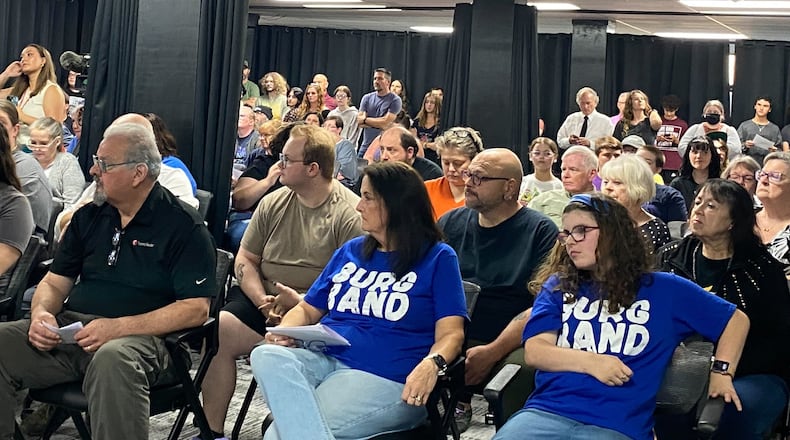 A crowd of more than 100 people packed Miamisburg School District's Board of Education meeting Thursday, Sept. 18, 2025 after two teachers were placed on paid leave for remarks concerning conservative political figure Charlie Kirk. More than a dozen students, parents and alumni voiced support of music teacher/band director Steve Aylward. ERIC SCHWARTZBERG/STAFF