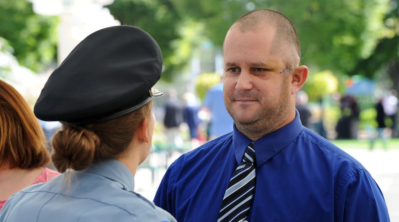 Dayton Police Officer Thadeu Holloway, talks with other officers during the Montgomery County 14th Annual Law Enforcrment Memorial Ceremony Monday Sept. 27, 2021. Holloway, an eight-year veteran of the Dayton Police Department, was shot in the left side of his face during a struggle with a suspect last Thursday. MARSHALL GORBY\STAFF