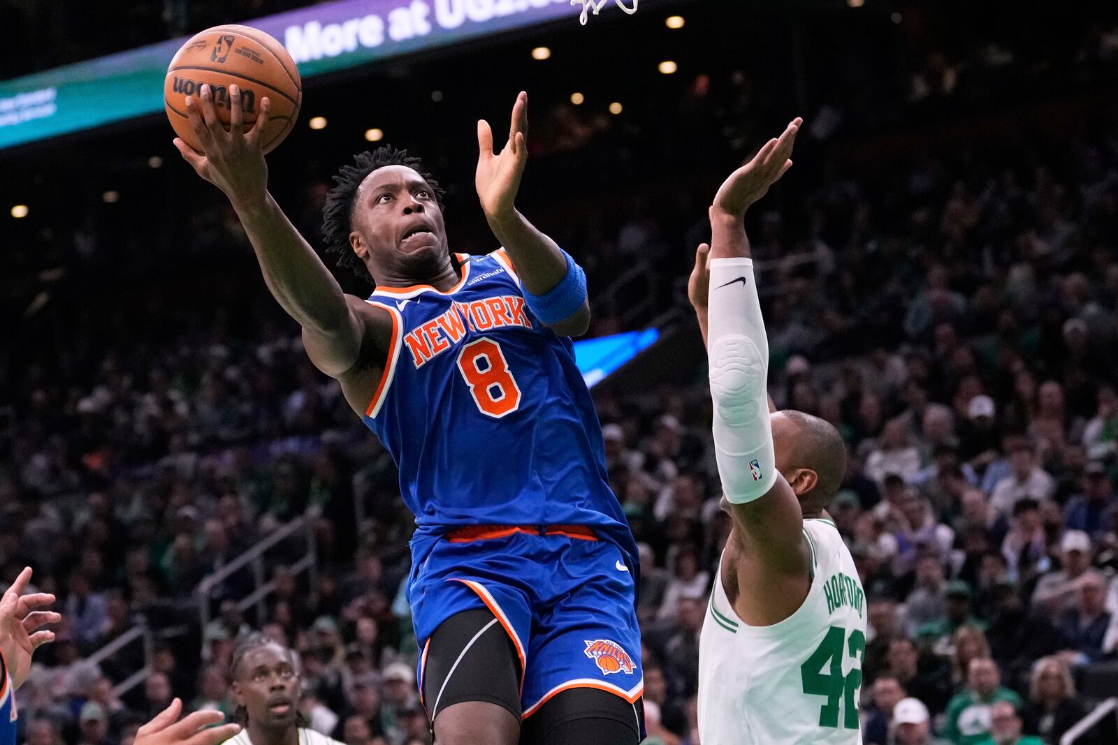 New York Knicks forward OG Anunoby (8) drives to the basket against Boston Celtics center Al Horford (42) during the first half of Game 1 of an NBA basketball second-round playoff series Monday, May 5, 2025, in Boston. (AP Photo/Charles Krupa)