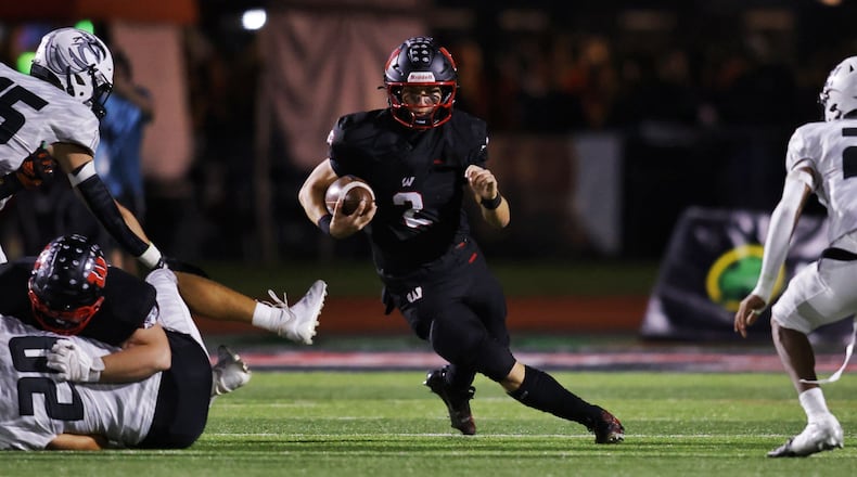 Lakota West quarterback Sam Wiles runs the ball during their football game against Lakota East Friday, Oct. 18, 2024 at Lakota West High School in West Chester Township. NICK GRAHAM/STAFF