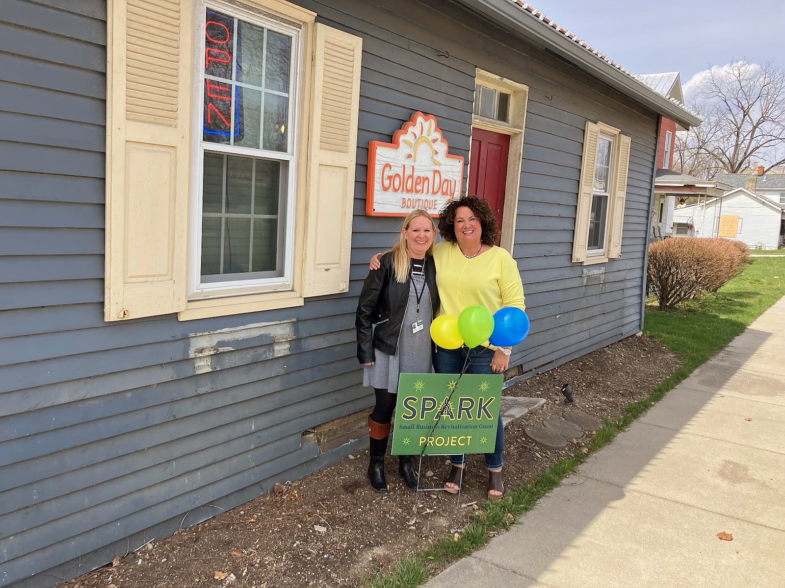 Every business approved for a West Chester Twp. Spark improvement grant received a sign and balloons. Golden Day Boutique’s Caron Armstrong is pictured with Katy Kanelopoulos, the township’s community development director, before improvements were made. Contributed photo