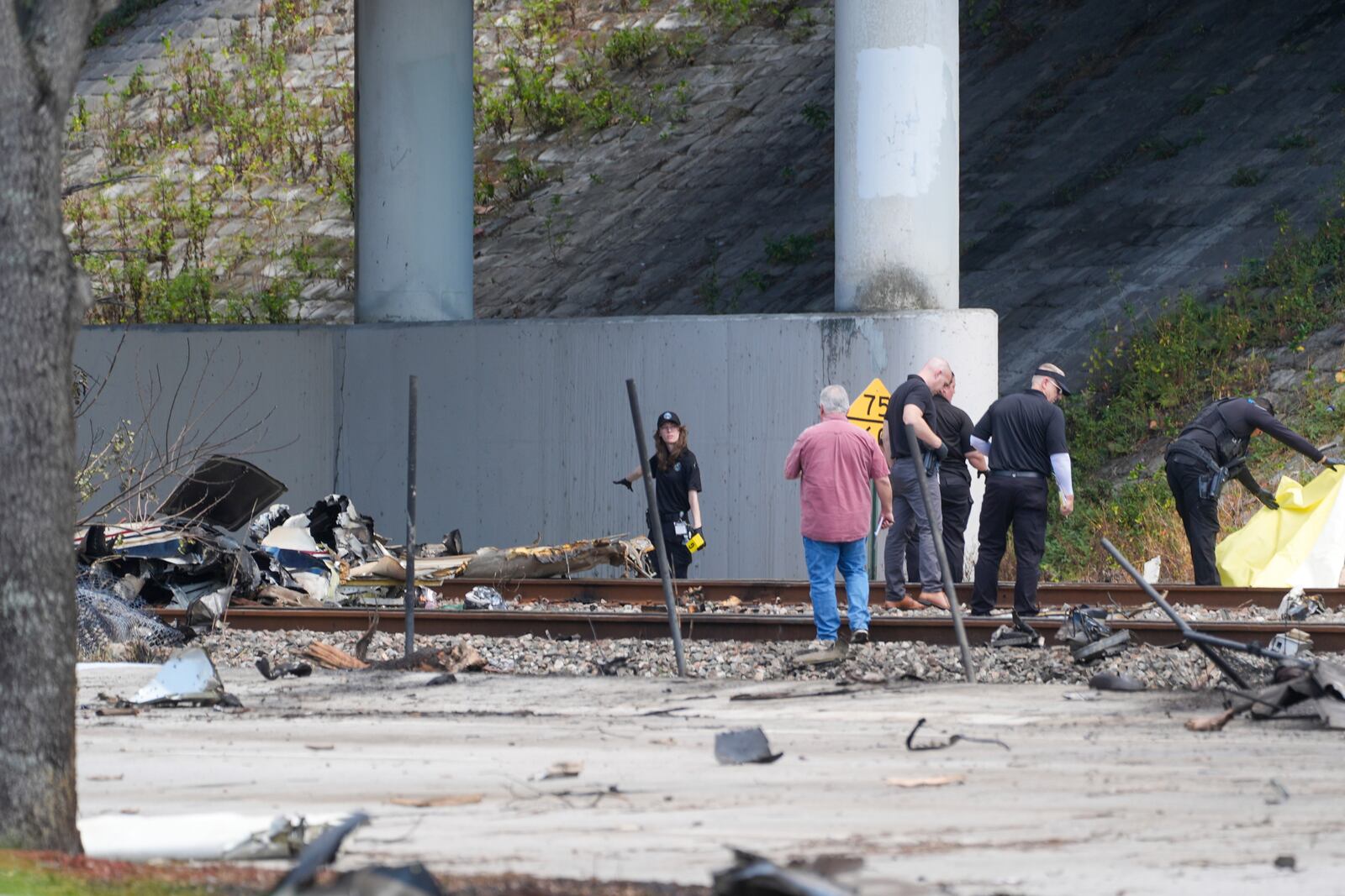 Emergency crew inspect the site of a small plane crash Friday, April 11, 2025 in Boca Raton, Fla. (AP Photo/Marta Lavandier)