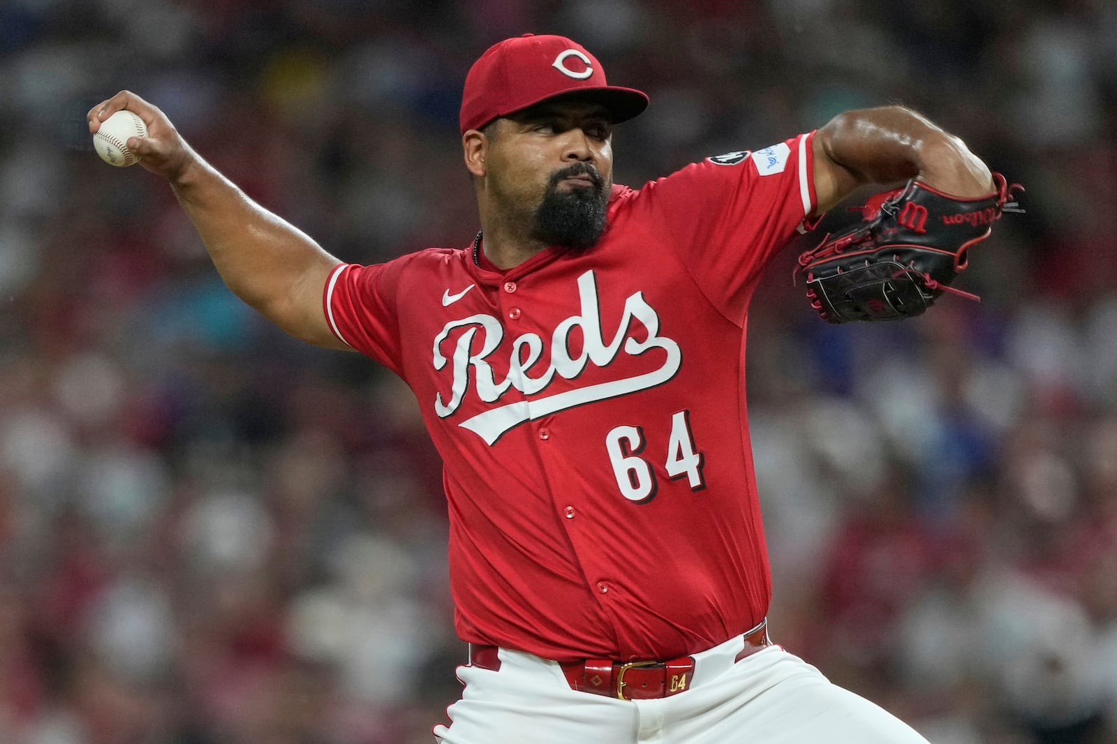 Cincinnati Reds' Tony Santillan throws during the ninth inning of a baseball game against the Los Angeles Dodgers Wednesday, July 30, 2025, in Cincinnati. (AP Photo/Carolyn Kaster)