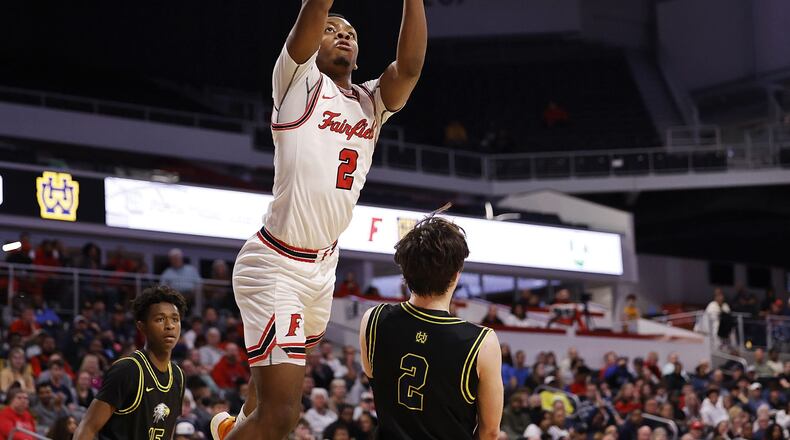 Fairfield's Deshawne Crim goes to the hoop over Walnut Hills guard Max Poynter during their Division I District final Sunday, March 6, 2022 at Fifth Third Arena on the University of Cincinnati campus. Fairfield won 55-52. NICK GRAHAM/STAFF