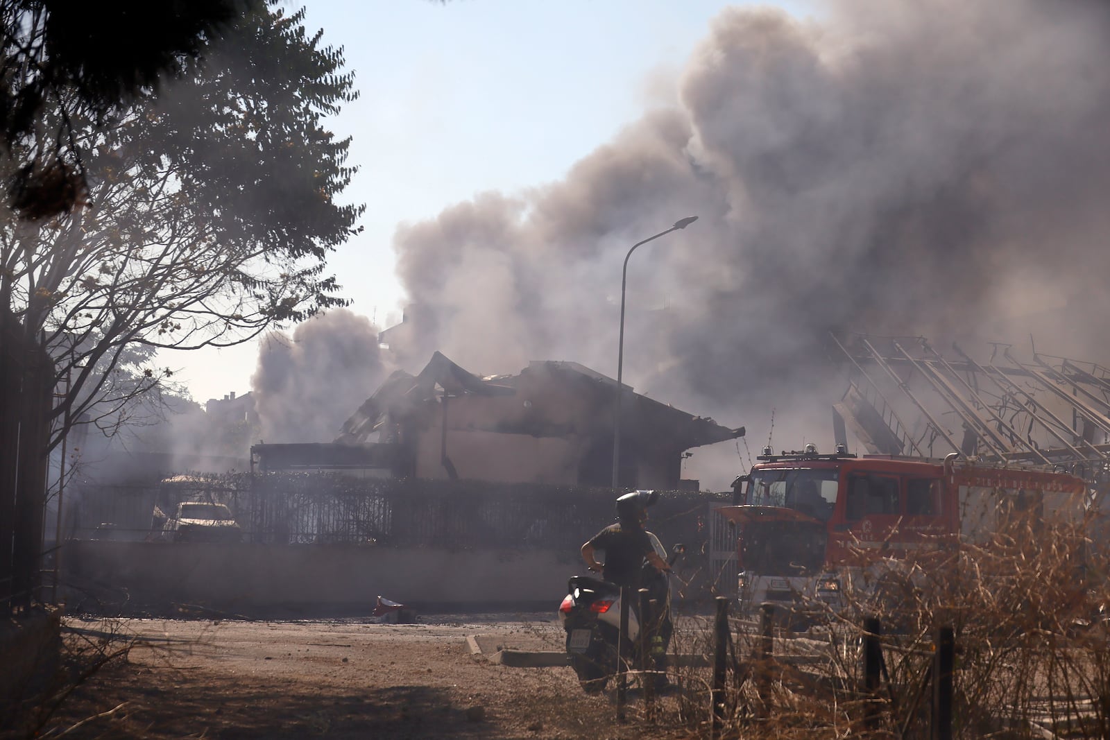 Smoke rises after a gas station exploded on the outskirts of Rome, Friday, July 4, 2025. (Cecilia Fabiano/LaPresse via AP)