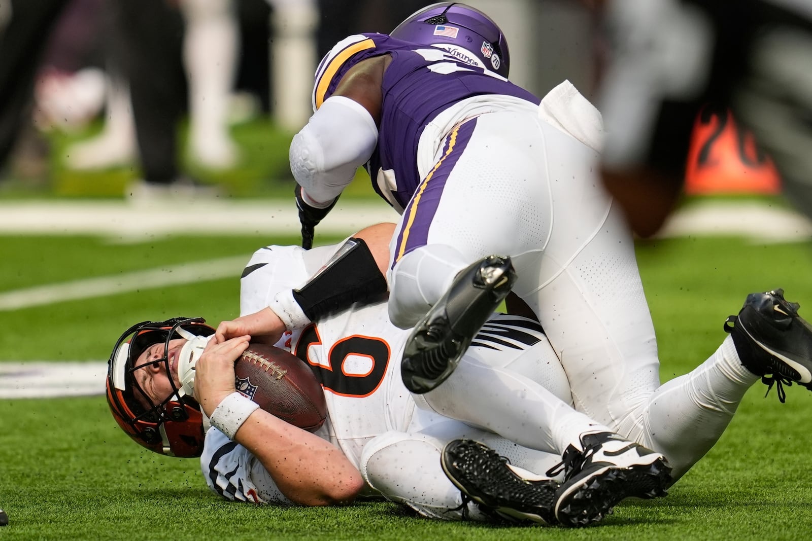Cincinnati Bengals quarterback Jake Browning (6) is sacked by Minnesota Vikings' Austin Keys during the second half of an NFL football game, Sunday, Sept. 21, 2025, in Minneapolis. (AP Photo/Mike Stewart)