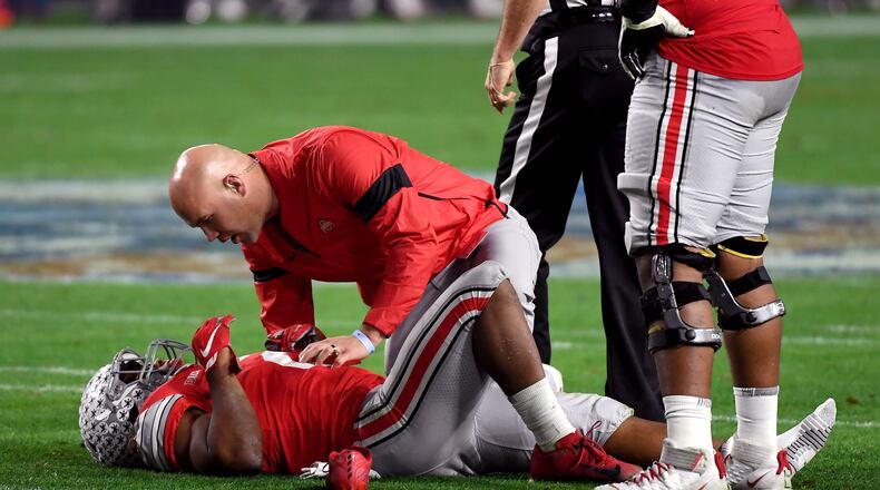 GLENDALE, ARIZONA - DECEMBER 28: J.K. Dobbins #2 of the Ohio State Buckeyes is checked by the trainer against the Clemson Tigers in the first half during the College Football Playoff Semifinal at the PlayStation Fiesta Bowl at State Farm Stadium on December 28, 2019 in Glendale, Arizona. (Photo by Norm Hall/Getty Images)