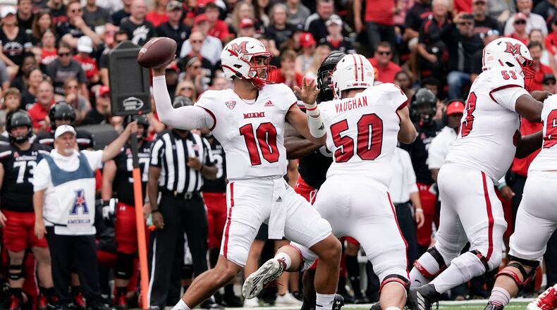 Miami (Ohio) quarterback AJ Mayer (10) throws during the first half of an NCAA college football game against Cincinnati, Saturday, Sept. 4, 2021, in Cincinnati. (AP Photo/Jeff Dean)