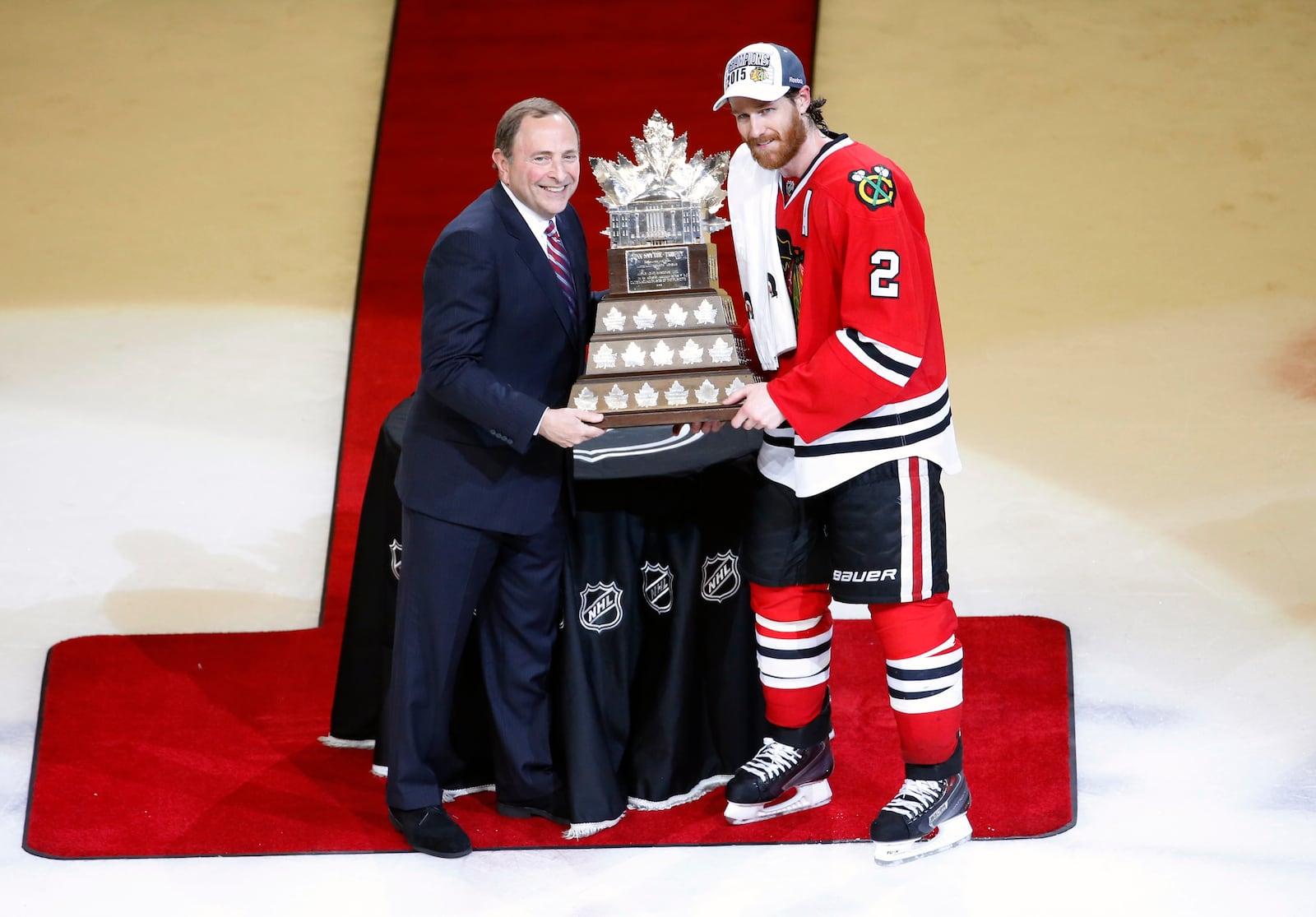 FILE - Chicago Blackhawks' Duncan Keith, right, is awarded the The Conn Smythe Trophy by commissioner Gary Bettman after the Blackhawks 2-0 victory over the Tampa Bay Lightning in Game 6 of the NHL hockey Stanley Cup Final series on June 15, 2015, in Chicago. (AP Photo/Charles Rex Arbogast, File)
