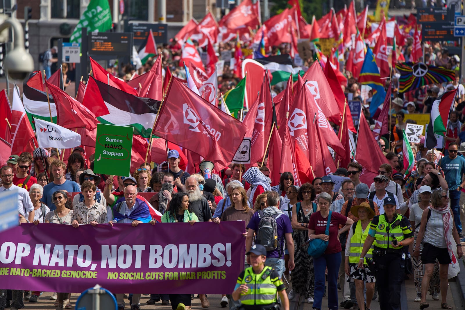 People carry banners and flags during a demonstration ahead of the NATO summit in The Hague, Netherlands, Sunday, June 22, 2025. (AP Photo/Peter Dejong)