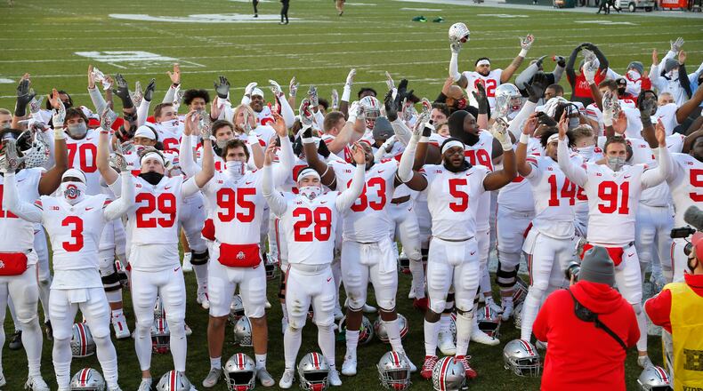 Ohio State players celebrate following an NCAA college football game against Michigan State, Saturday, Dec. 5, 2020, in East Lansing, Mich.  (AP Photo/Al Goldis)