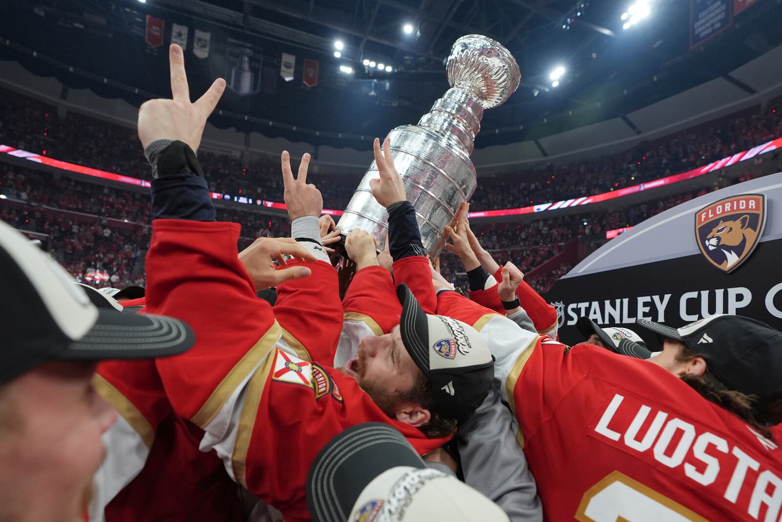 Florida Panthers left wing Matthew Tkachuk helps raise the Stanley Cup trophy after defeating the Edmonton Oilers in Game 6 of the NHL hockey Stanley Cup Final Tuesday, June 17, 2025, in Sunrise, Fla. (AP Photo/Lynne Sladky)