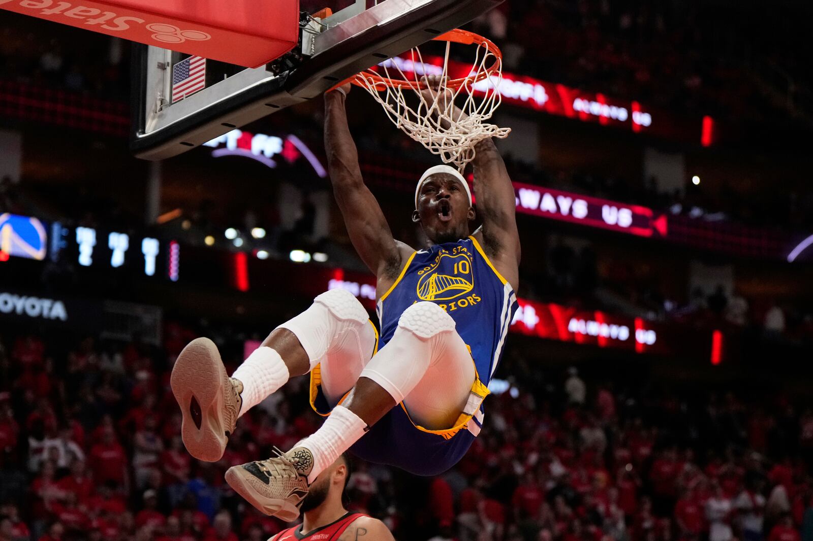 Golden State Warriors forward Jimmy Butler III (10) dunks during the second half of Game 1 of an NBA basketball first-round playoff series against the Houston Rockets in Houston, Sunday, April 20, 2025. (AP Photo/Ashley Landis)