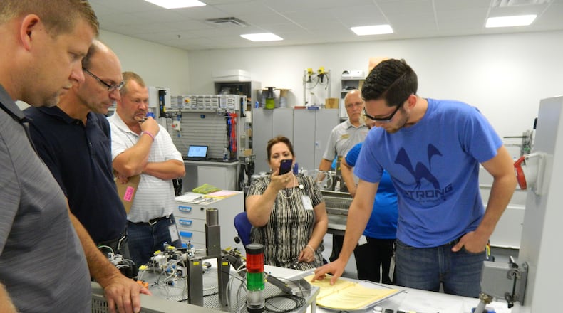 Spencer Kuritar (in blue shirt) at work at Festo taking an AHK certification course designed for technicians working with high voltage applications. Here he is learning how to wire a 480 VAC cabinet.