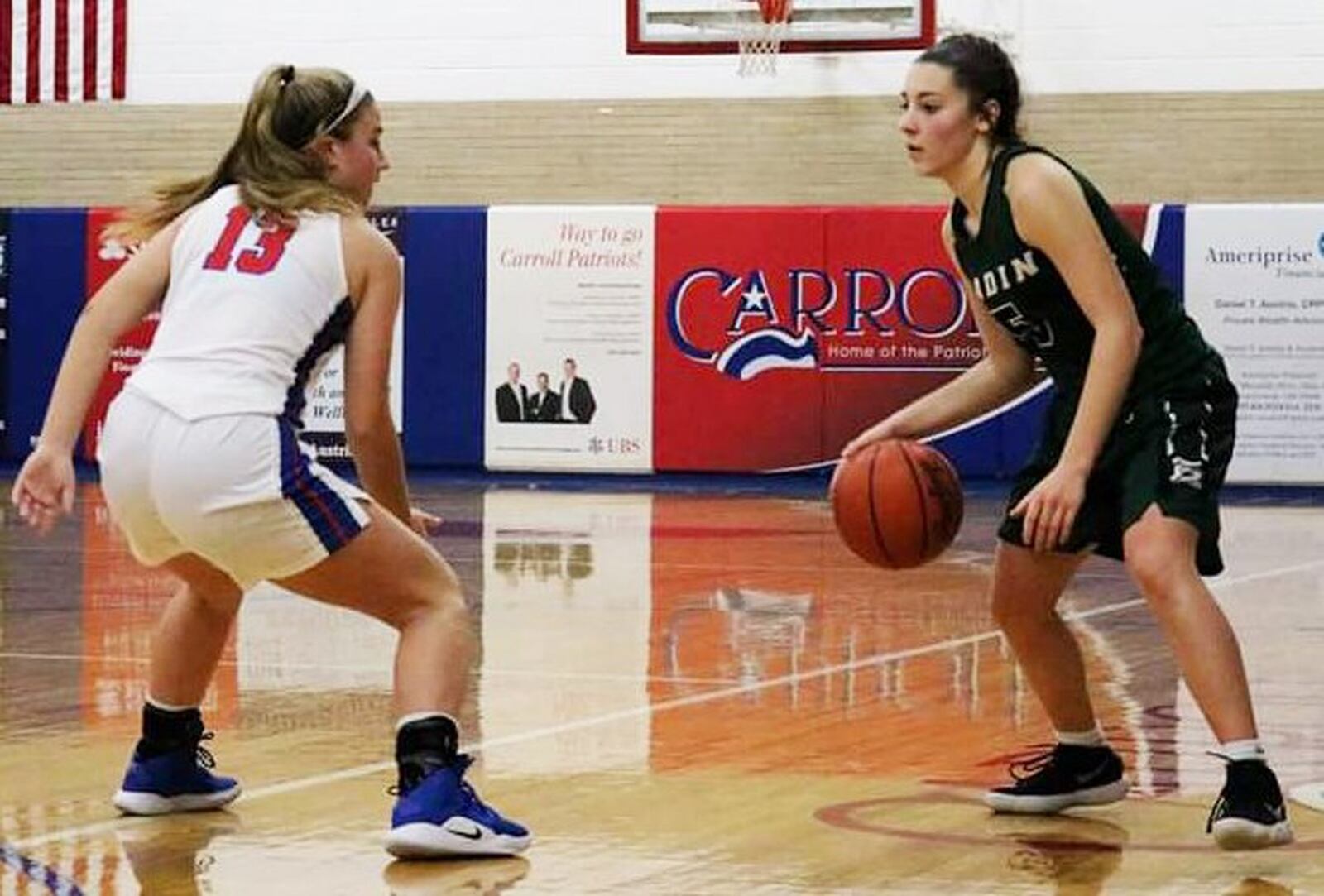 Badin’s Jaelynn Scowden is defended by Carroll’s Jillian Roberts (13) during Saturday afternoon’s game in Riverside. Carroll won 64-57. CONTRIBUTED PHOTO BY TERRI ADAMS