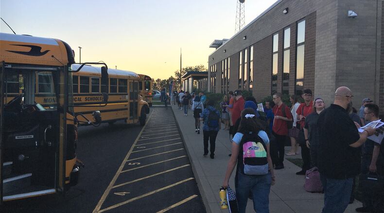 Butler Tech students spent sunrise Thursday at the career school's main bus hub at its Fairfield Twp. campus as classes opened for the new school year. Butler Tech is one of the largest career schools in Ohio and it has four, high -school campuses across Butler County and many satellite learning programs at local high schools. Also starting classes on a staggered schedule Thursday morning was Middletown Schools. (Photo By Michael D. Clark\Journal-News)