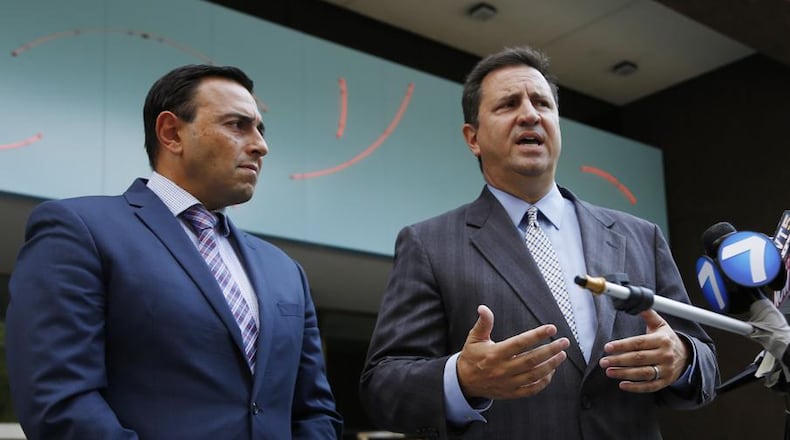 Attorney Nick Gounaris, right, and co-counsel Tony Abboud speak after a hearing in Federal Court for their client Ethan Kollie who was charged with lying on a federal firearms form. Kollie was a friend of the Oregon District shooter. TY GREENLEES / STAFF