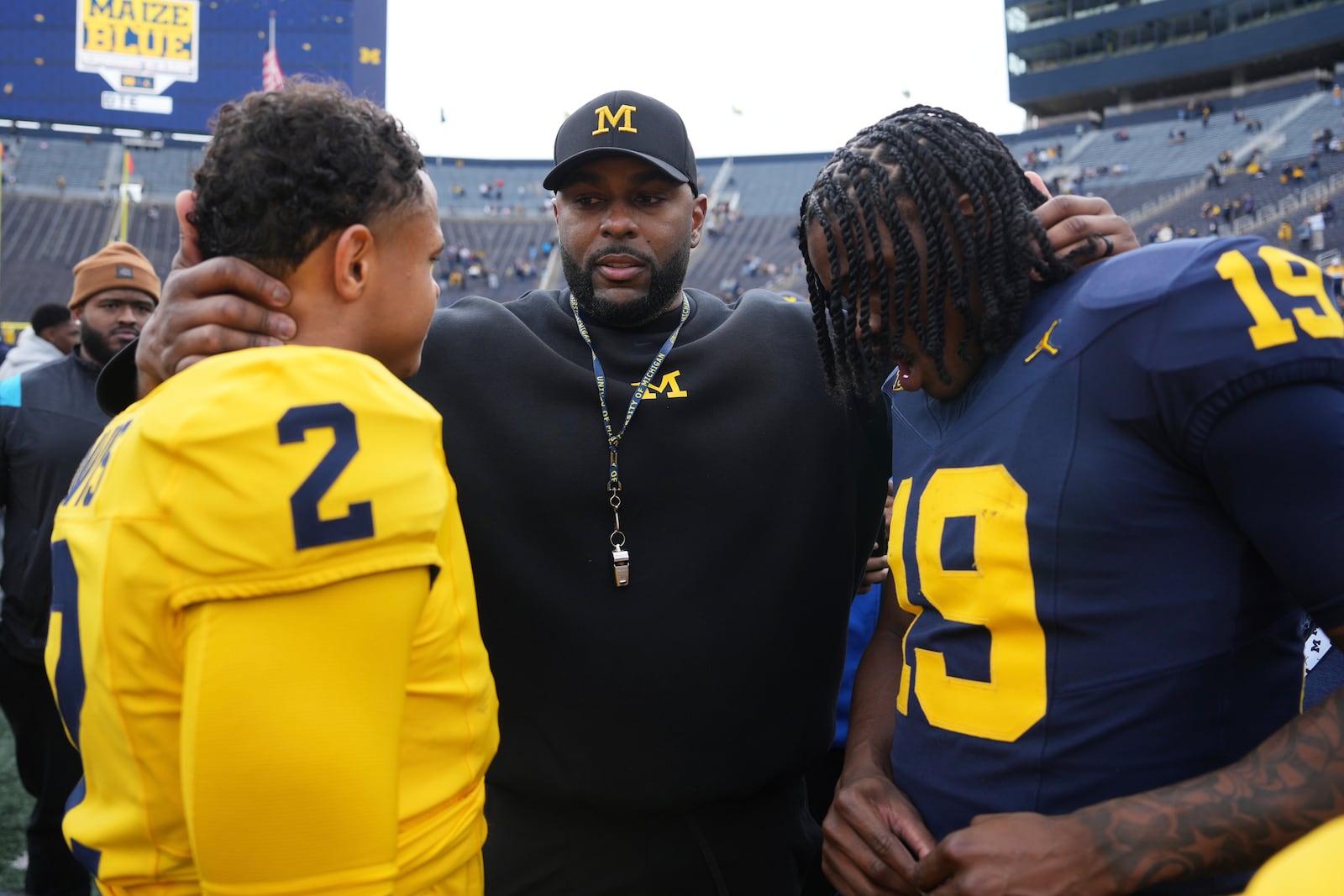 Michigan head coach Sherrone Moore, center, talks with quarterbacks Jadyn Davis (2) and Bryce Underwood (19) after an NCAA college football spring game in Ann Arbor, Mich., Saturday, April 19, 2025. (AP Photo/Paul Sancya)