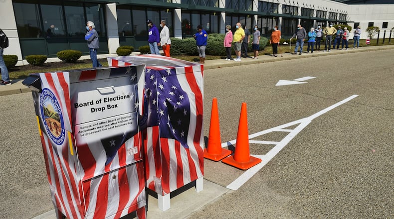 Voters line up at the Butler County Board of Elections on the first day of early voting Tuesday, October 6, 2020 in Hamilton. NICK GRAHAM / STAFF