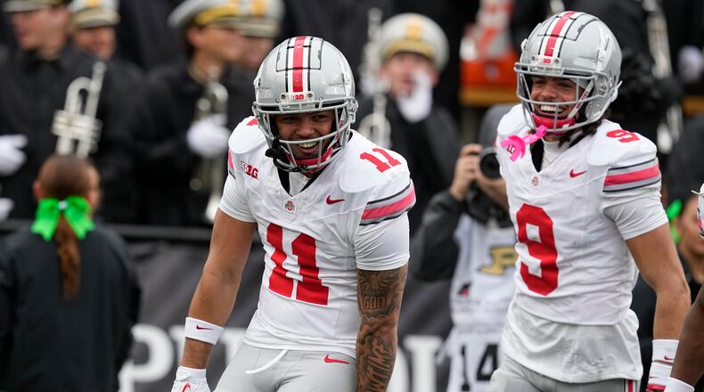 Ohio State wide receiver Brandon Inniss (11) celebrates a touchdown reception with Jayden Ballard (9) during the second half of an NCAA college football game against Purdue, Saturday, Oct. 14, 2023, in West Lafayette, Ind. Ohio State won 41-7. (AP Photo/Darron Cummings)
