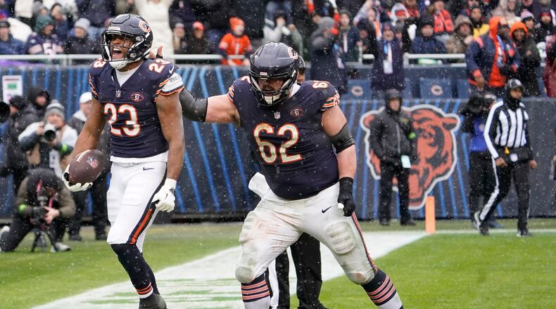 Chicago Bears running back Roschon Johnson (23) celebrates a touchdown with Chicago Bears guard Lucas Patrick (62) in the first half of an NFL football game against the Atlanta Falcons in Chicago, Sunday, Dec. 31, 2023. (AP Photo/David Banks)