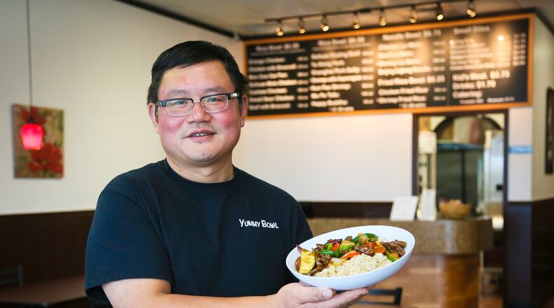John Chen, owner of Yummy Bowl, hold one of thier most popular dishes, the Sichuan Sizzling Beef.