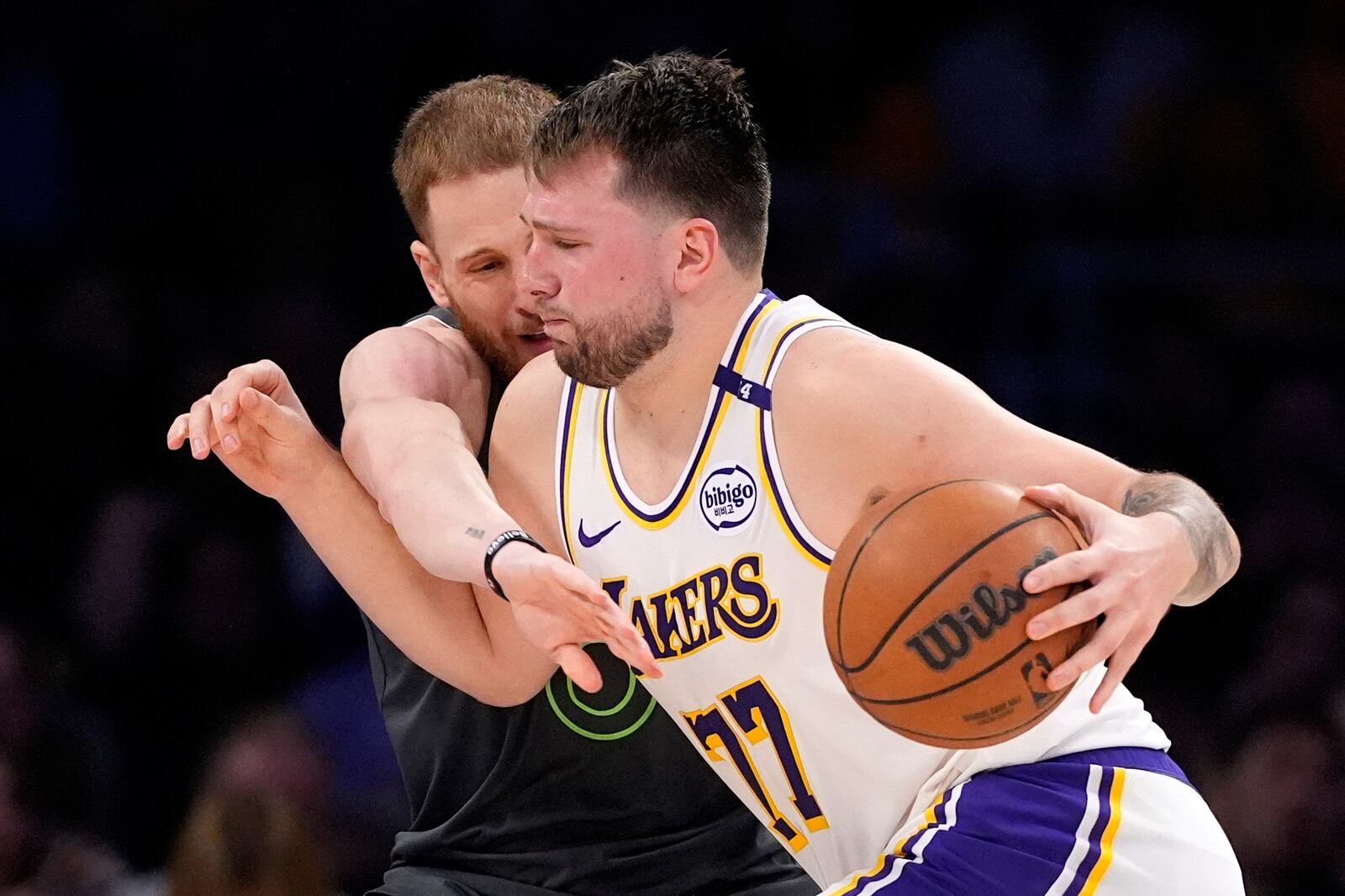 Los Angeles Lakers guard Luka Doncic, right, dries toward the basket as Minnesota Timberwolves guard Donte DiVincenzo defends during the second half in Game 1 of an NBA first-round playoff series Saturday, April 19, 2025, in Los Angeles. (AP Photo/Mark J. Terrill)