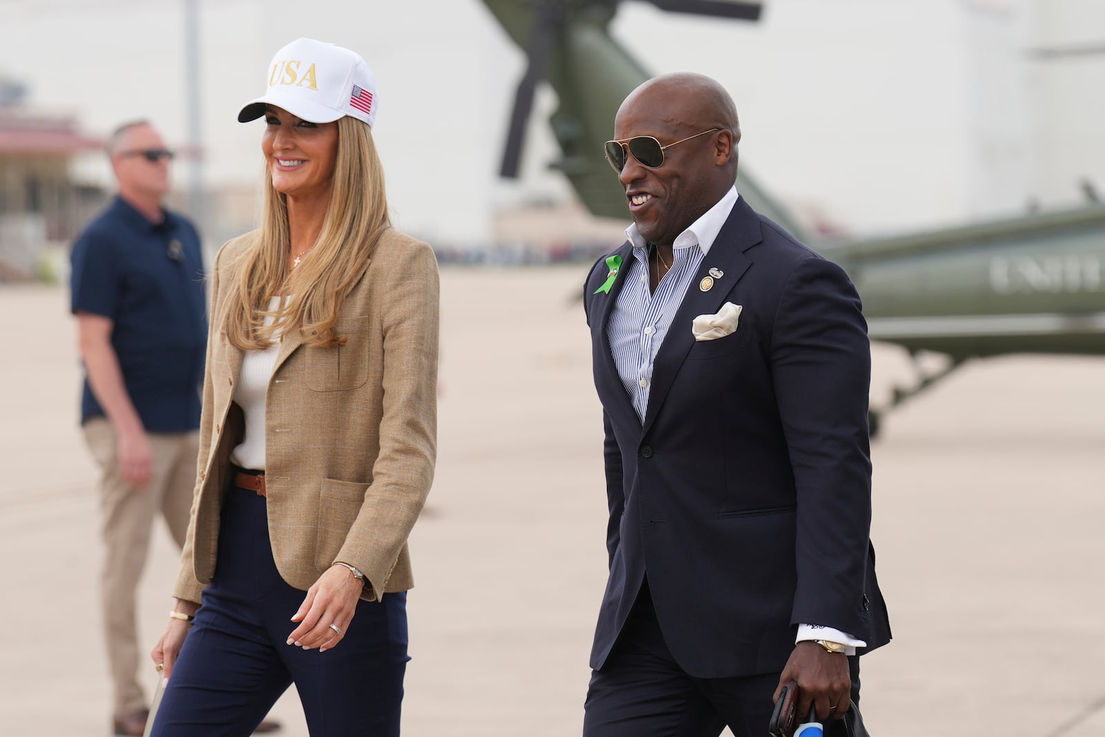 Small Business Administration Chief Kelly Loeffler, left, and Rep. Wesley Hunt, R-Texas, arrive at Kelly Field air base in San Antonio, Texas, en route to observe flood damage in Kerrville, Texas, Friday, July 11, 2025. (AP Photo/Jacquelyn Martin)