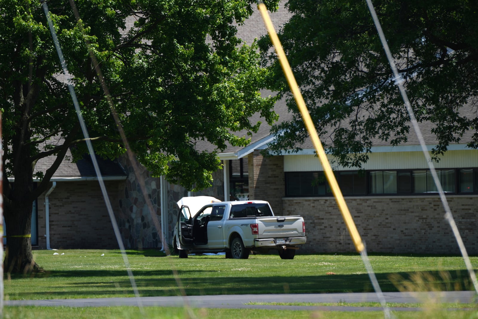 An idle vehicle sits near CrossPointe Community Church in Wayne, Mich., Sunday, June 23, 2025. (AP Photo/Paul Sancya)