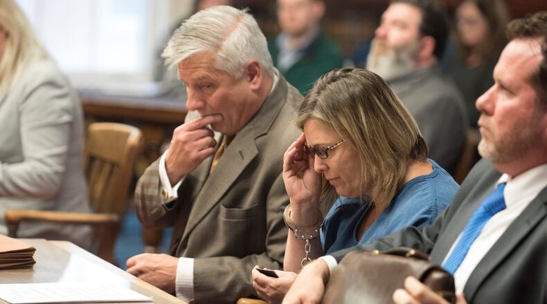 Angela Wagner, 48, adjusts her reading glasses as her attorney Robert Krapenc, left, looks at a copy of the indictment charging Wagner in the 2016 Pike County murders. ROBERT MCGRAW / CHILLICOTHE GAZETTE / POOL PHOTO