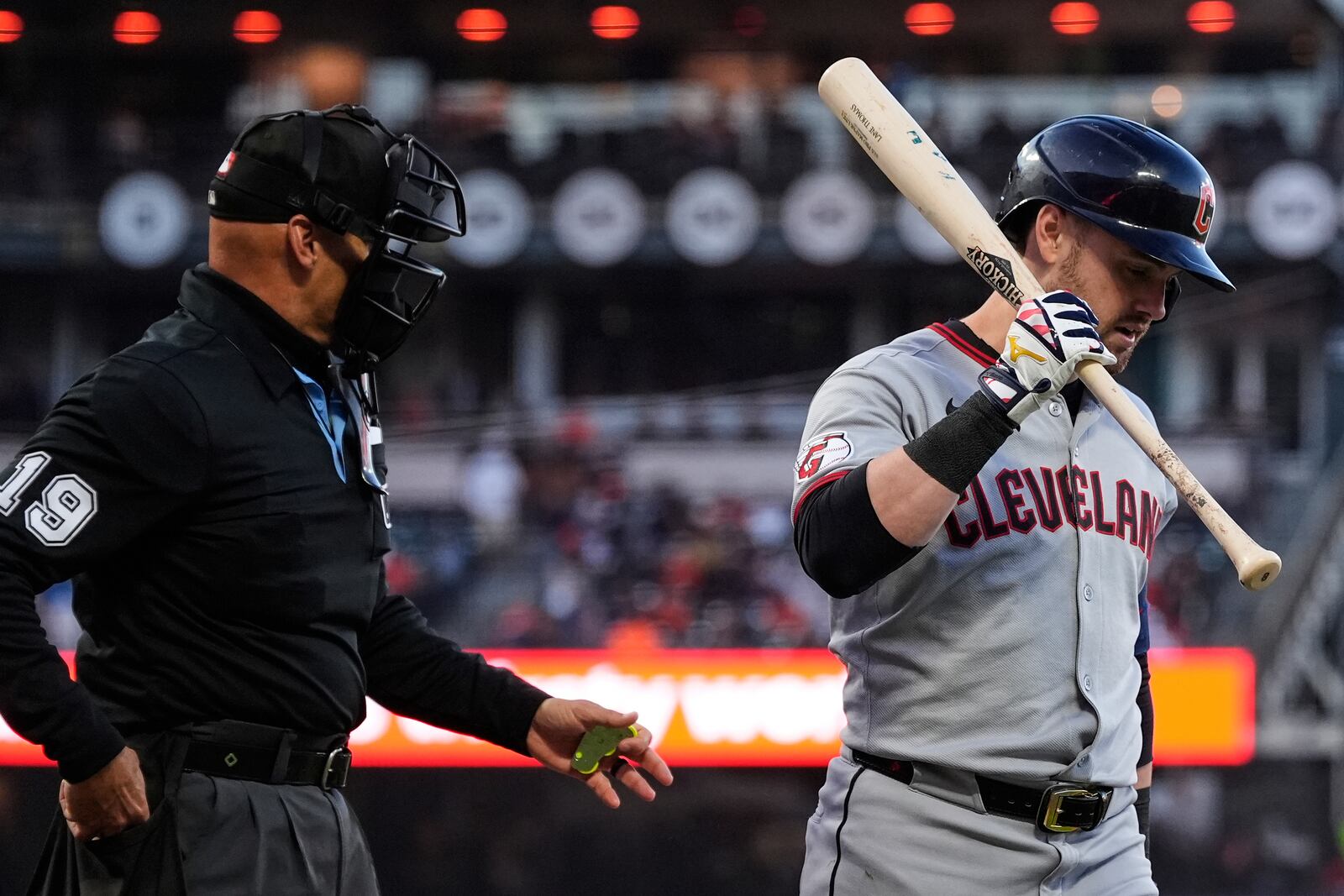 Cleveland Guardians' Lane Thomas, right, walks to the dugout after being called out on strikes during the fifth inning of a baseball game against the San Francisco Giants, Wednesday, June 18, 2025, in San Francisco. (AP Photo/Godofredo A. Vásquez)