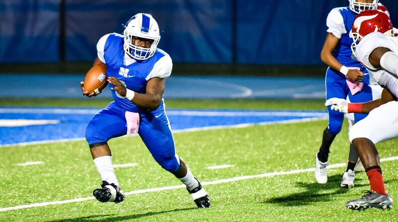 Hamilton’s Maleek Jarrett carries the ball during a game against Princeton on Oct. 20 at Virgil Schwarm Stadium in Hamilton. NICK GRAHAM/STAFF