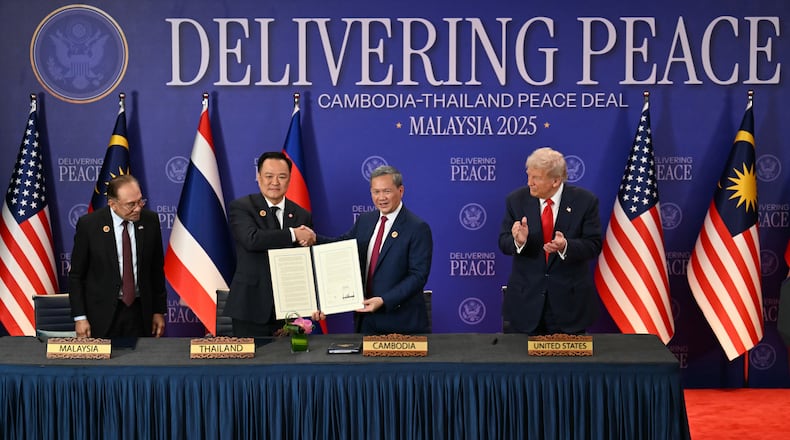 FILE - Malaysia's Prime Minister Anwar Ibrahim, left, and U.S. President Donald Trump, right, watch as Thailand's Prime Minister Anutin Charnvirakul, second left, and Cambodia's Prime Minister Hun Manet hold up a document after the ceremonial signing of a ceasefire agreement between Thailand and Cambodia on the sidelines of the 47th Association of Southeast Asian Nations (ASEAN) summit in Kuala Lumpur, Malaysia, on Oct. 26, 2025. (Mohd Rasfan/Pool Photo via AP, File)