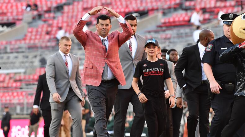 COLUMBUS, OH - OCTOBER 5: Head Coach Ryan Day of the Ohio State Buckeyes salutes fans with an “O” as he walks through Ohio Stadium before a game against the Michigan State Spartans on October 5, 2019 in Columbus, Ohio. (Photo by Jamie Sabau/Getty Images)