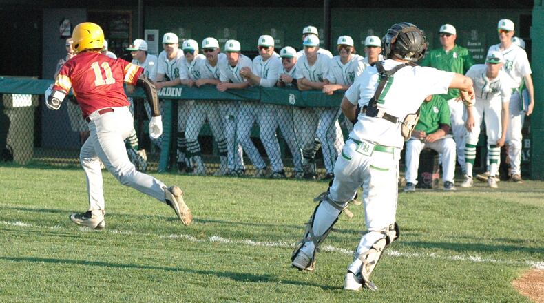 Badin catcher Dylan Ballauer prepares to throw toward first base as Tyler Hoover (11) of Ross heads in that direction Monday night at Alumni Field in Joyce Park. Badin won the Butler County baseball clash 6-2. RICK CASSANO/STAFF