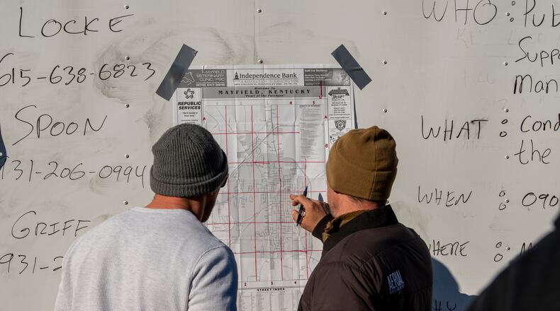 Volunteers coordinate efforts to bring supplies and remove debris in Mayfield, Ky. on Monday, Dec. 13, 2021, after a tornado swept across the region. Determining how many people died in the tornadoes that ravaged the central U.S. on Friday has been a challenging task so far, with estimates fluctuating as search teams continue to spread out amid vast fields of rubble in an effort to rescue the living and account for the dead. (Johnny Milano/The New York Times)