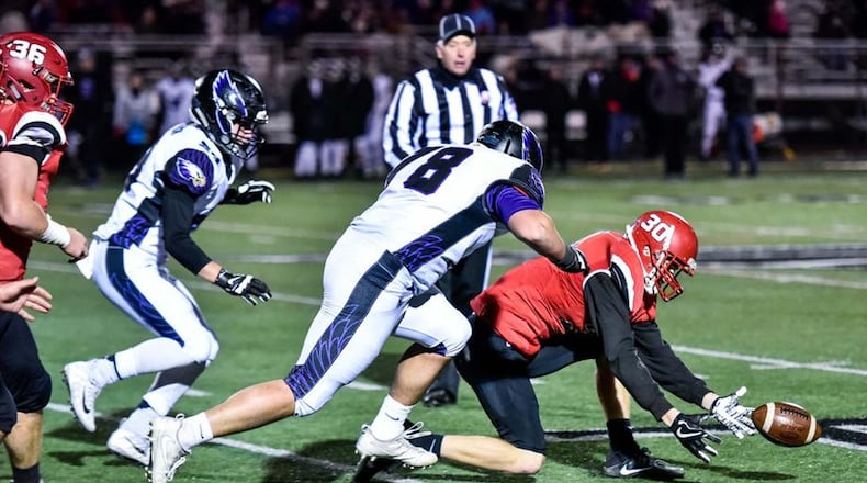 Madison’s Levi McMonigle (30) recovers a Cincinnati Hills Christian Academy fumble in front of the Eagles’ Peyton Breese (78) during a Division V, Region 20 semifinal at Lakota East on Nov. 10. NICK GRAHAM/STAFF