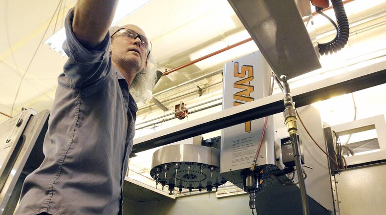 Machinist James Mitchner sets up a CNC machine at Starwin Industries entrance in Kettering. The small manufacturing company conducts half of its business as a defense manufacturer according to company president Rick Little. TY GREENLEES / STAFF