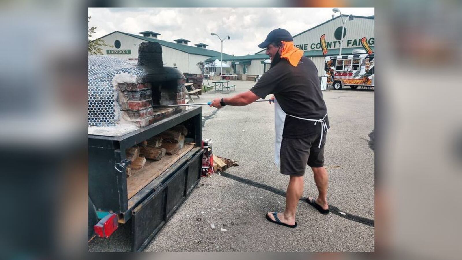 Michael Manning, 45, owner of Pizza Cicerone in Fairfield, prepares pizza in his wood-oven during a food festival at the Greene County Fairgrounds. Pizza Cicerone recently opened inside Swine City Brewery on Industry Drive. SUBMITTED PHOTO