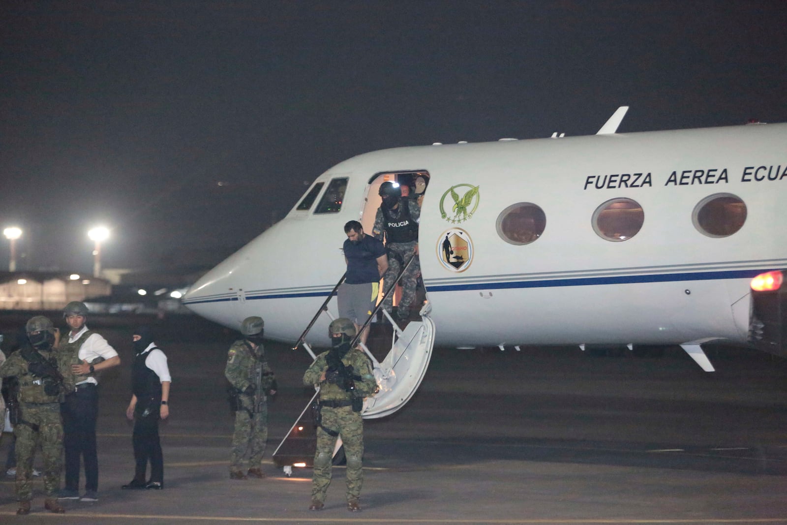 Escorted by soldiers and policemen, Adolfo "Fito" Macias, the leader of the Choneros gang, arrives in Guayaquil, Ecuador, after he was detained by police, Wednesday, June 25, 2025. (AP Photo/Joffre Flores)