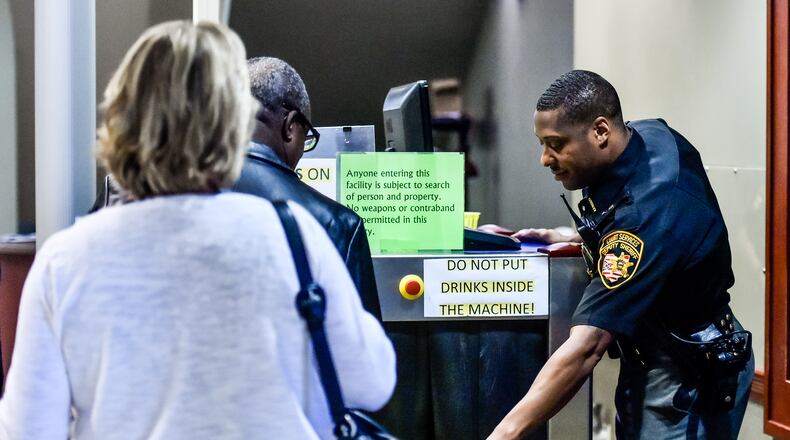 Leroy Cardwell, a Court Services deputy with the Butler County Sheriff’s Office, checks the security screening station as visitors enter Butler County Common Pleas Court Thursday, Aug. 24 at the Government Services Building on High Street in Hamilton. NICK GRAHAM/STAFF