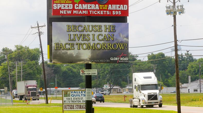 A billboard warned motorists of the speed cameras set up in New Miami, Thursday, June 27, 2013. GREG LYNCH / STAFF