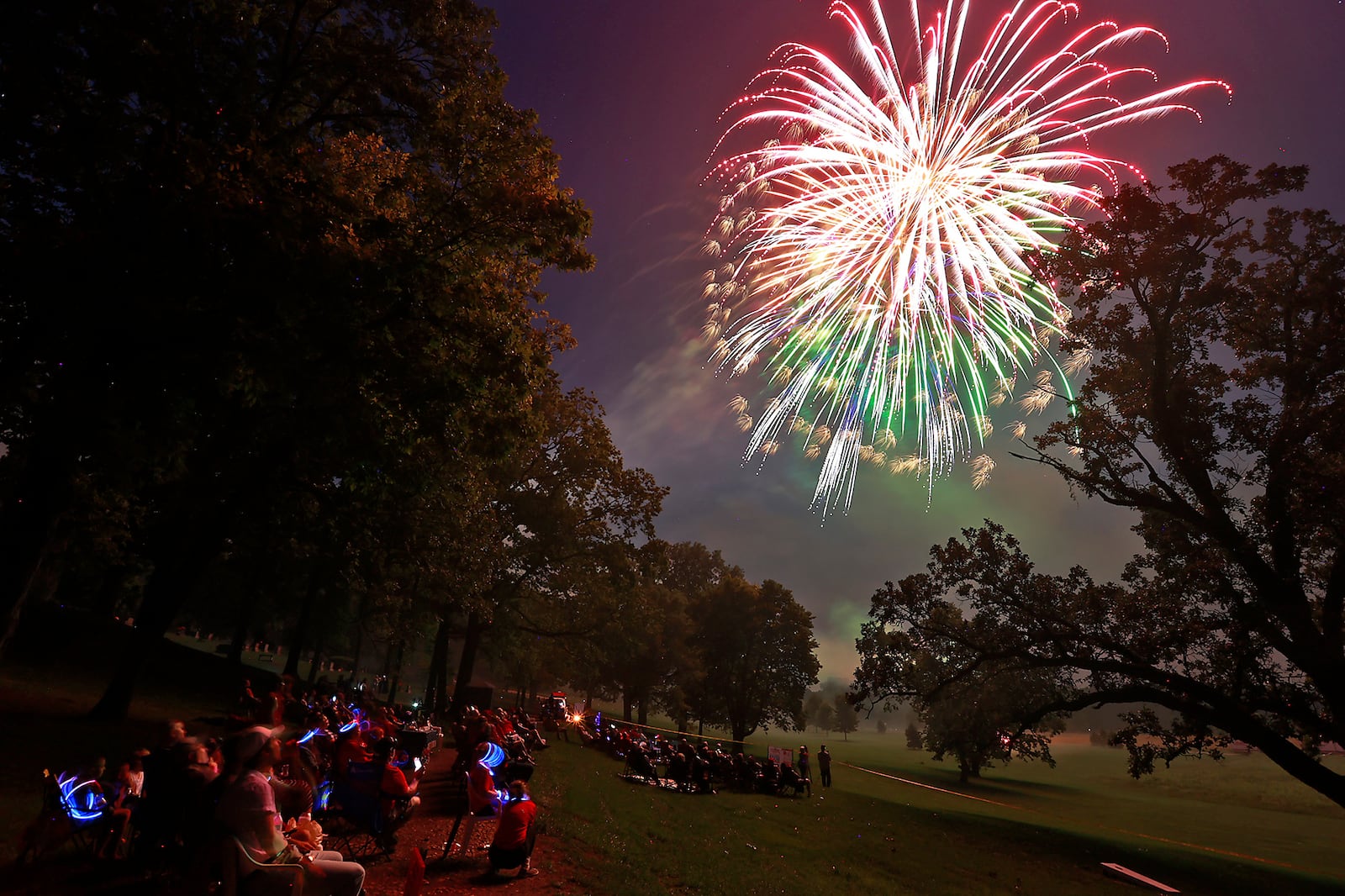 The rain stopped just in time for the Buck Creek Boom fireworks show to go on Monday, July 3, 2023 in Springfield. Spectators lined the shore of Buck Creek to watch the annual show put on by the National Trail Parks and Recreation District. BILL LACKEY/STAFF