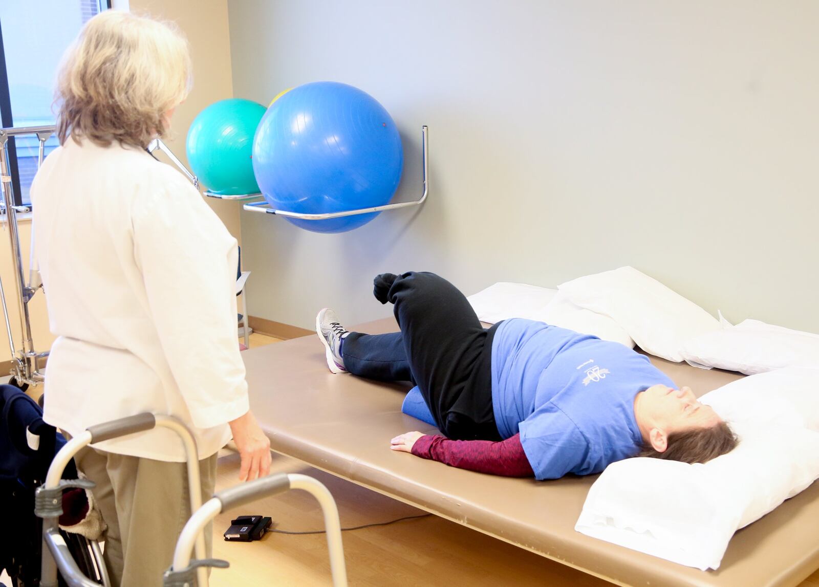Ann Brock, an emergency nurse at Atrium Medical Center, as well as a Monroe firefighter and paramedic, undergoes physical therapy at the hospital with physical therapy assistant Alice Cutter. Brock is learning to walk again after having part of her leg amputated after a motorcycle accident this fall. 