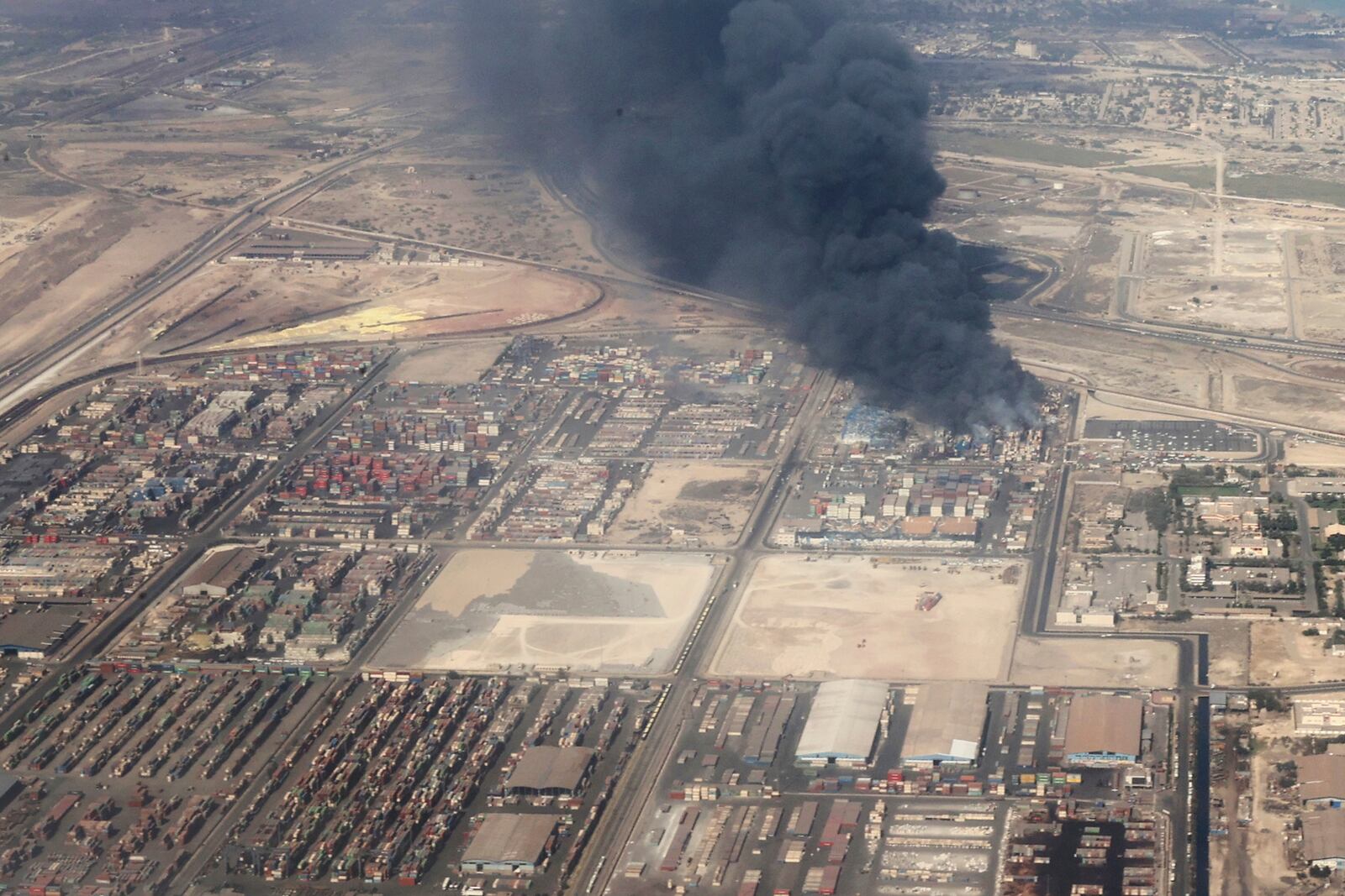 In this photo released by the Iranian Presidency Office, smoke rises in the sky on Sunday, April 27, 2025 after a massive explosion and fire rocked a port near the southern port city of Bandar Abbas, Iran, on Saturday. (Iranian Presidency Office via AP)